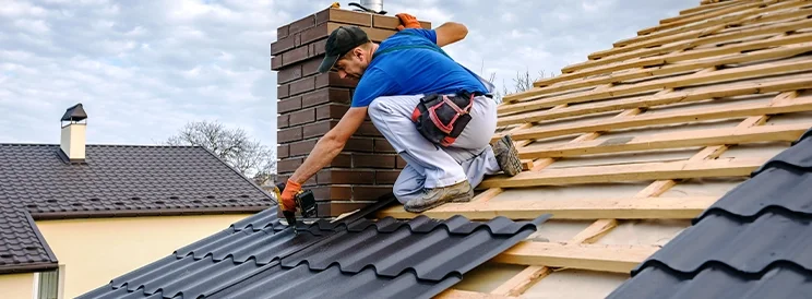 Fix-It Construction Services metal roof installation with contractor working on roof Harrisonburg VA