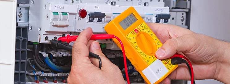 Fix-It Construction Services electrical safety inspection using multimeter on panel Harrisonburg VA