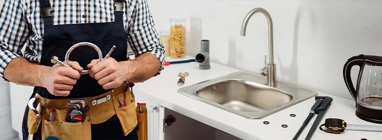 Fix-It Construction Services emergency plumbing repair at kitchen sink with tools Harrisonburg VA