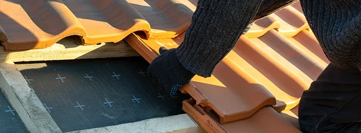 Fix-It Construction Services clay tile roof installation with contractor placing tiles Harrisonburg VA