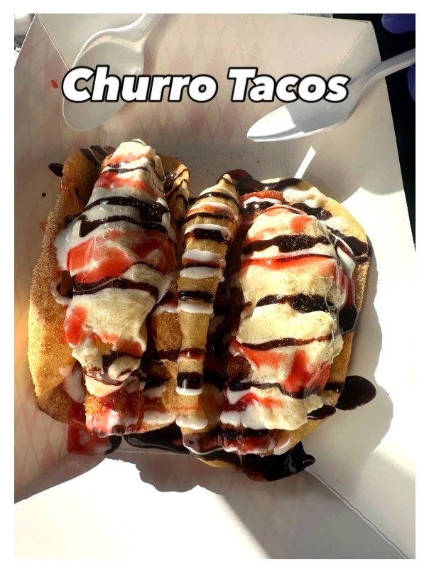 Churro tacos topped with ice cream, chocolate syrup, and strawberry syrup in a white takeout box.