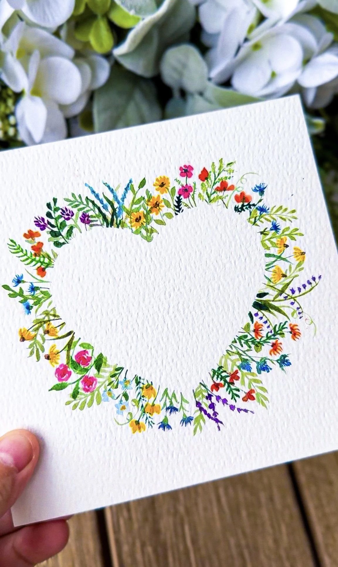 A heart shaped wreath of tiny wildflowers 