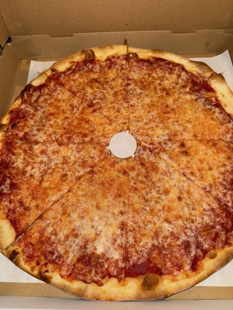 A large cheese pizza with a golden crust inside a cardboard delivery box.
