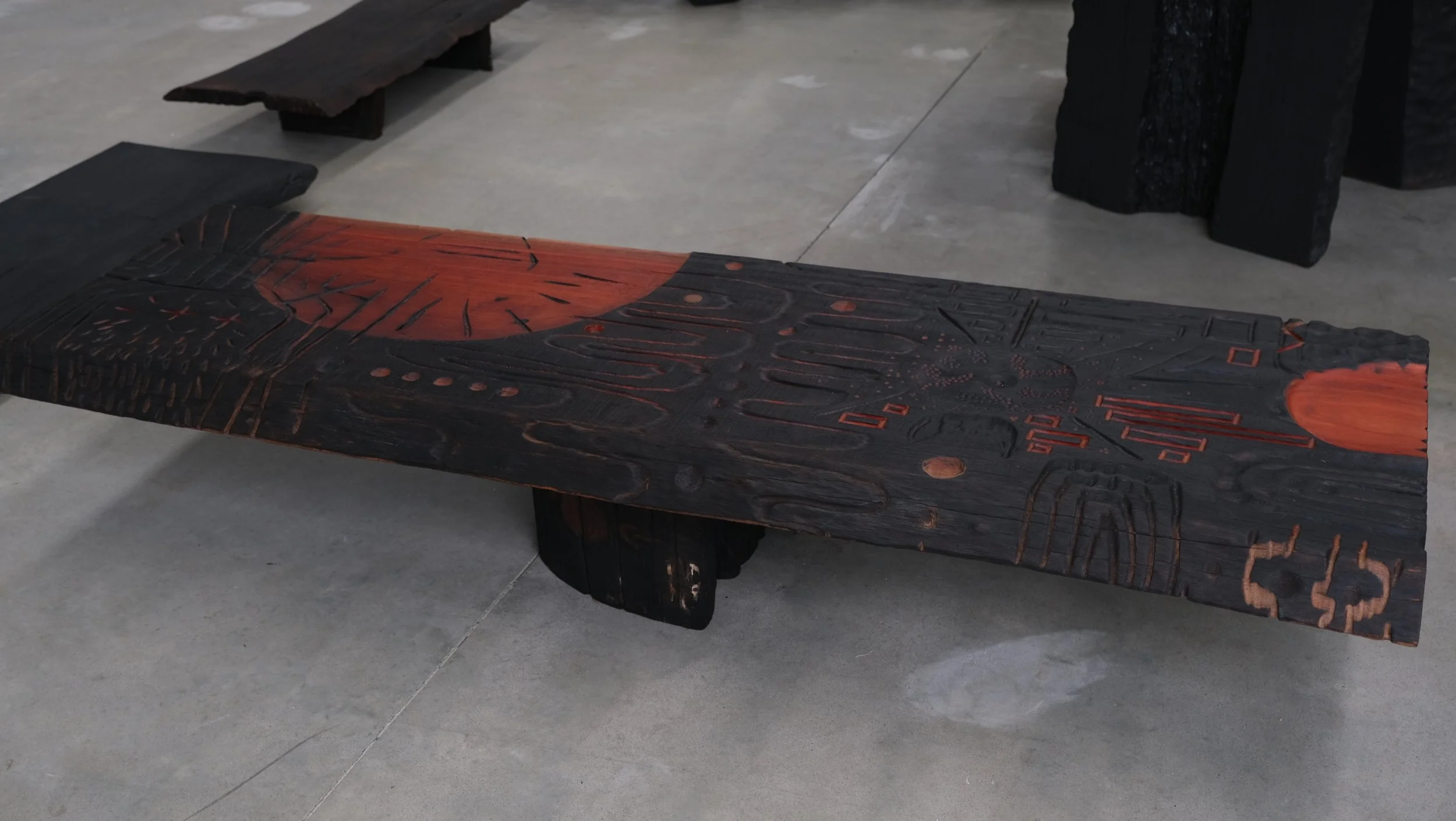 Reclaimed Blue Gum Shou Sugi Ban ceremonial table with carved symbols and red pigment — Kitsune Moon Byron Bay