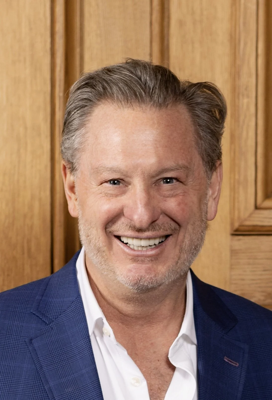 Professional portrait of Colin Lancaster, Wall Street macro investor and author of Fed Up!, wearing a blue blazer.