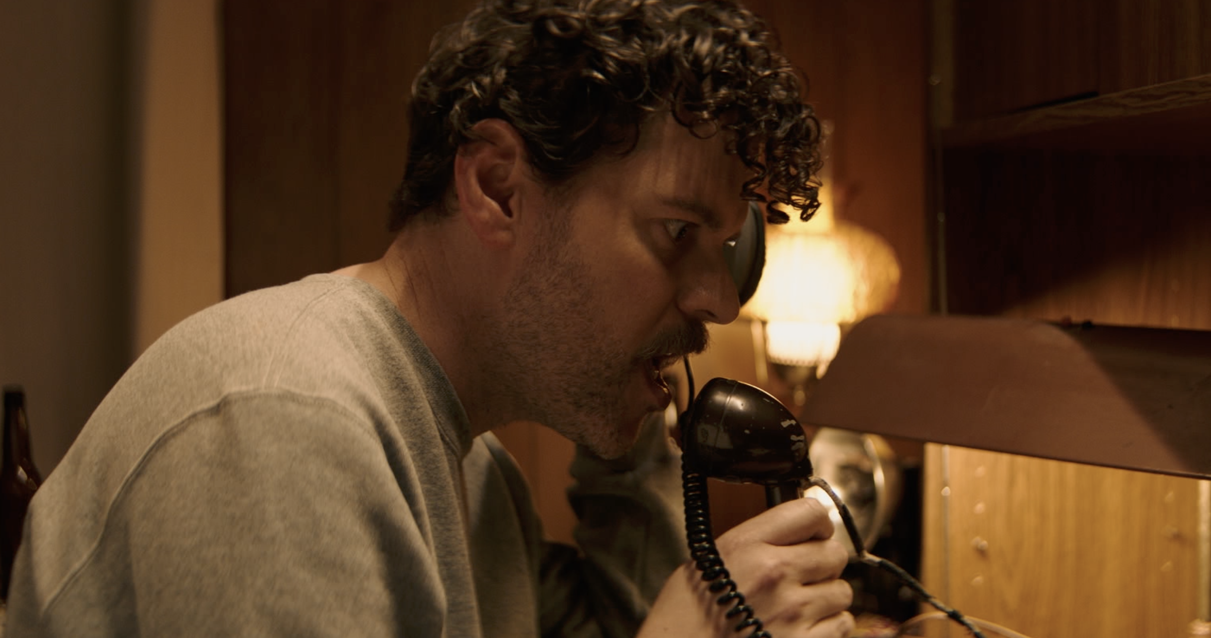 tales of the macabre film still of radio host on phone in dimly lit room