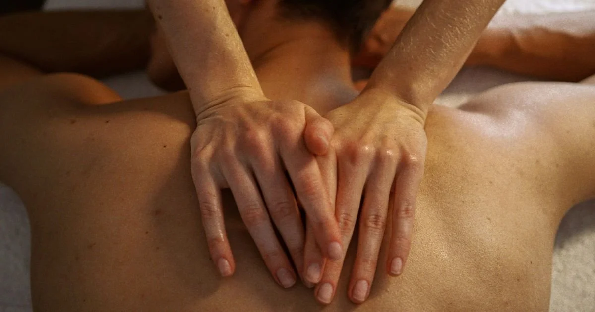 Person receiving a massage on their back in a spa or massage setting.