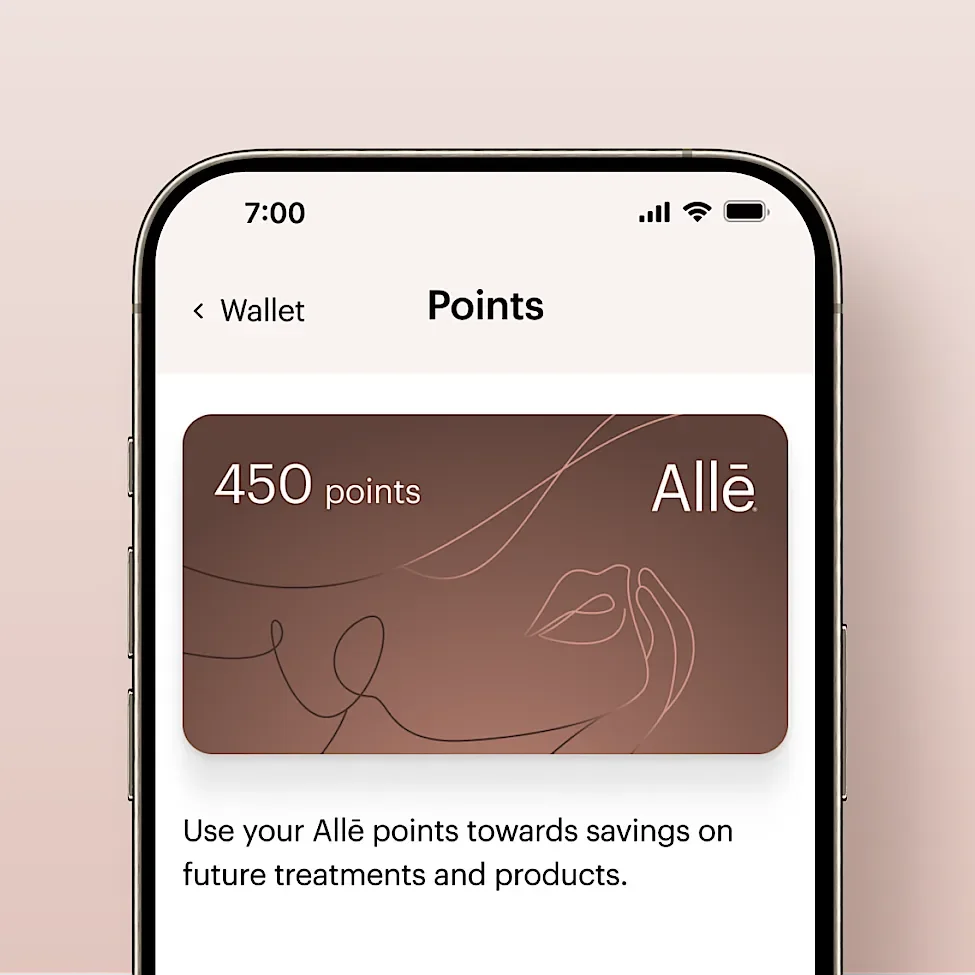 A smartphone screen showing a points balance of 450 points in a rewards app with a brown background and line art of a woman's face. Text indicates the points can be used towards future treatments and products.
