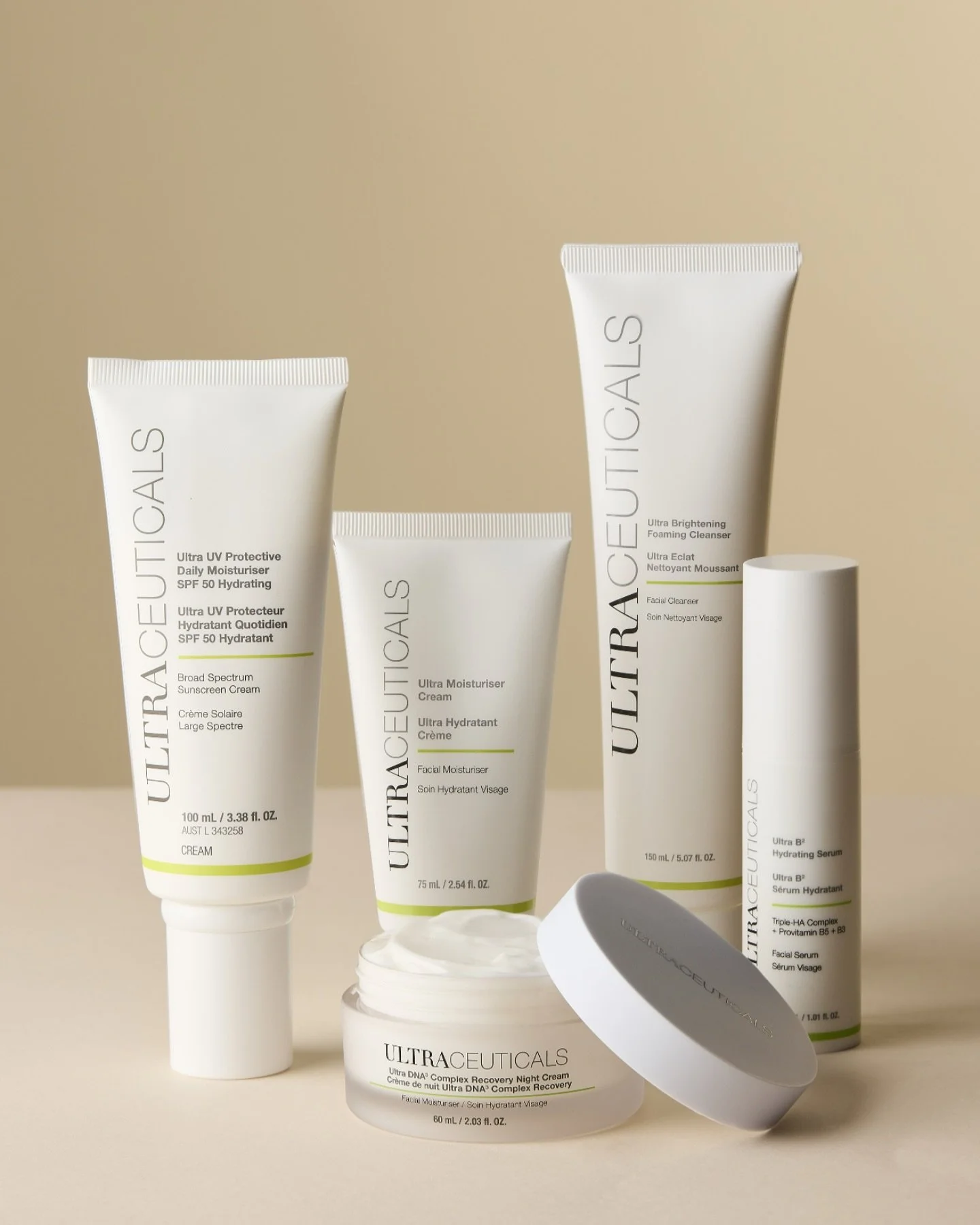 Collection of skincare products from Ultralecticals, including a broad spectrum sunscreen cream, a facial moisturizer, a hydrating serum, and a night cream, all in white tubes and jars with minimal design on a beige background.