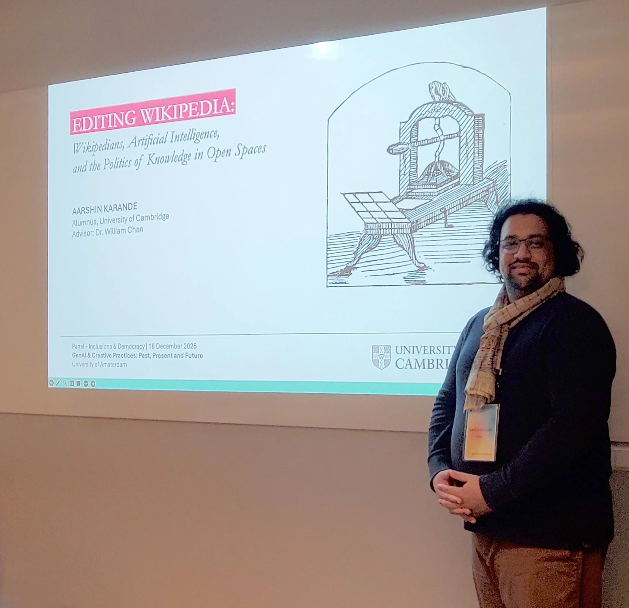 Aarshin Karande posing beside his presentation about artificial intelligence and Wikipedia at the University of Amsterdam in December 2025.