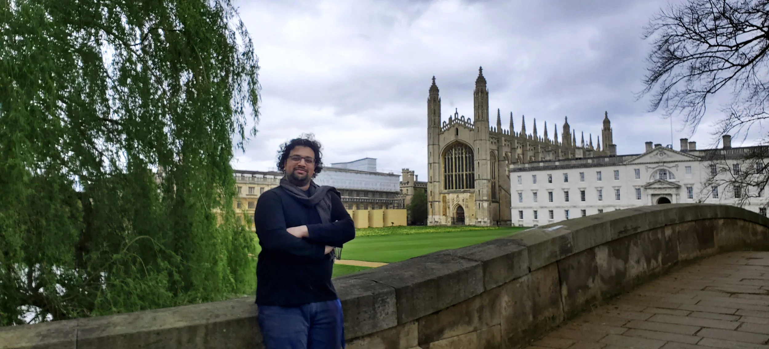 Aarshin Karande leans against a bridge over the River Cam at King's College, University of Cambridge in the Spring of 2024.