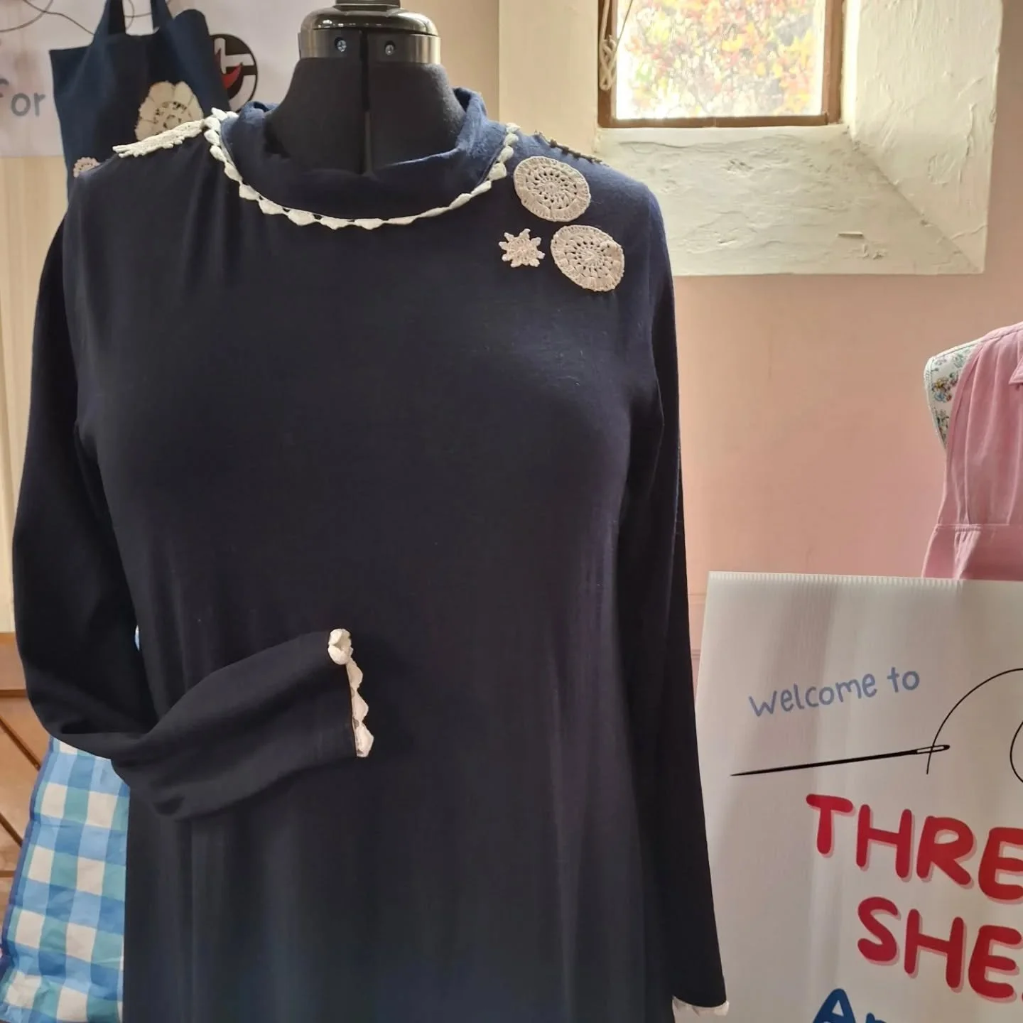 This lovely merino dress had been munched by moths, but volunteer extraordinare Verity made a few creative additions, banishing the holes in favour of on trend upcycled lace. Now the dress is inspiring us while waiting for a new forever home. If you'