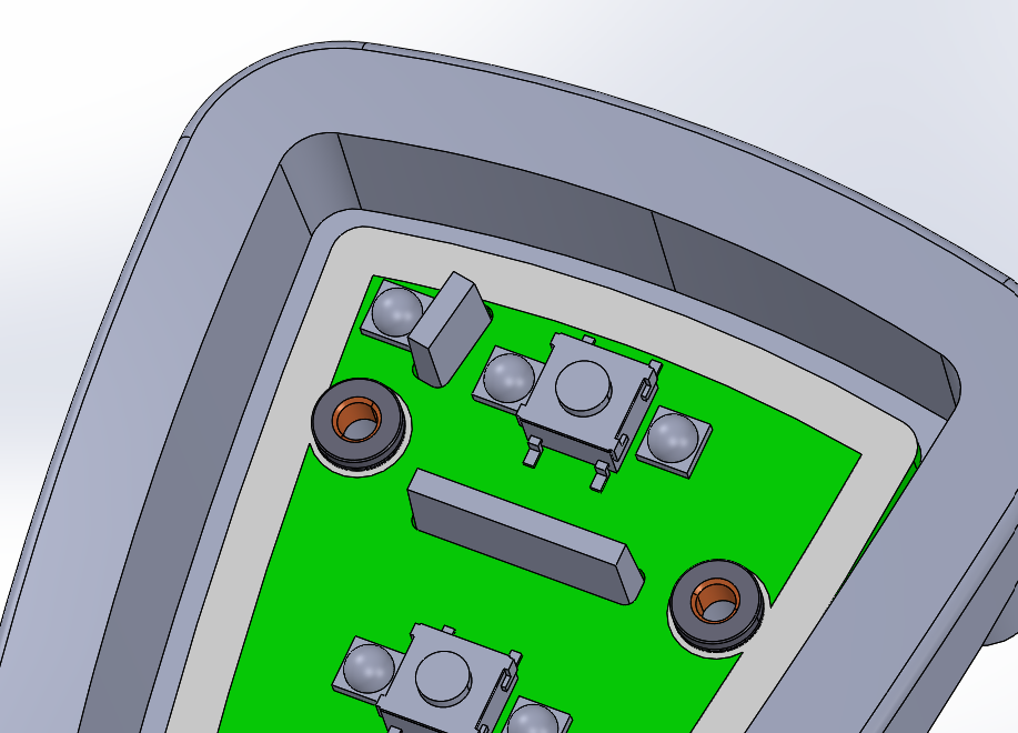 Close-up of electronic device interior showing green circuit board with components and two brown screw holes.