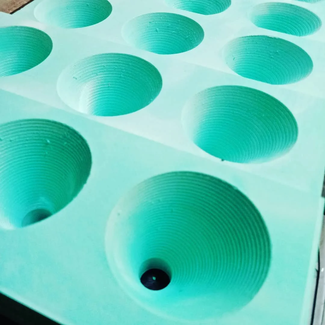 Optimising funnel design through prototyping.  Using CNC machining to test various angles and depths of funnel.