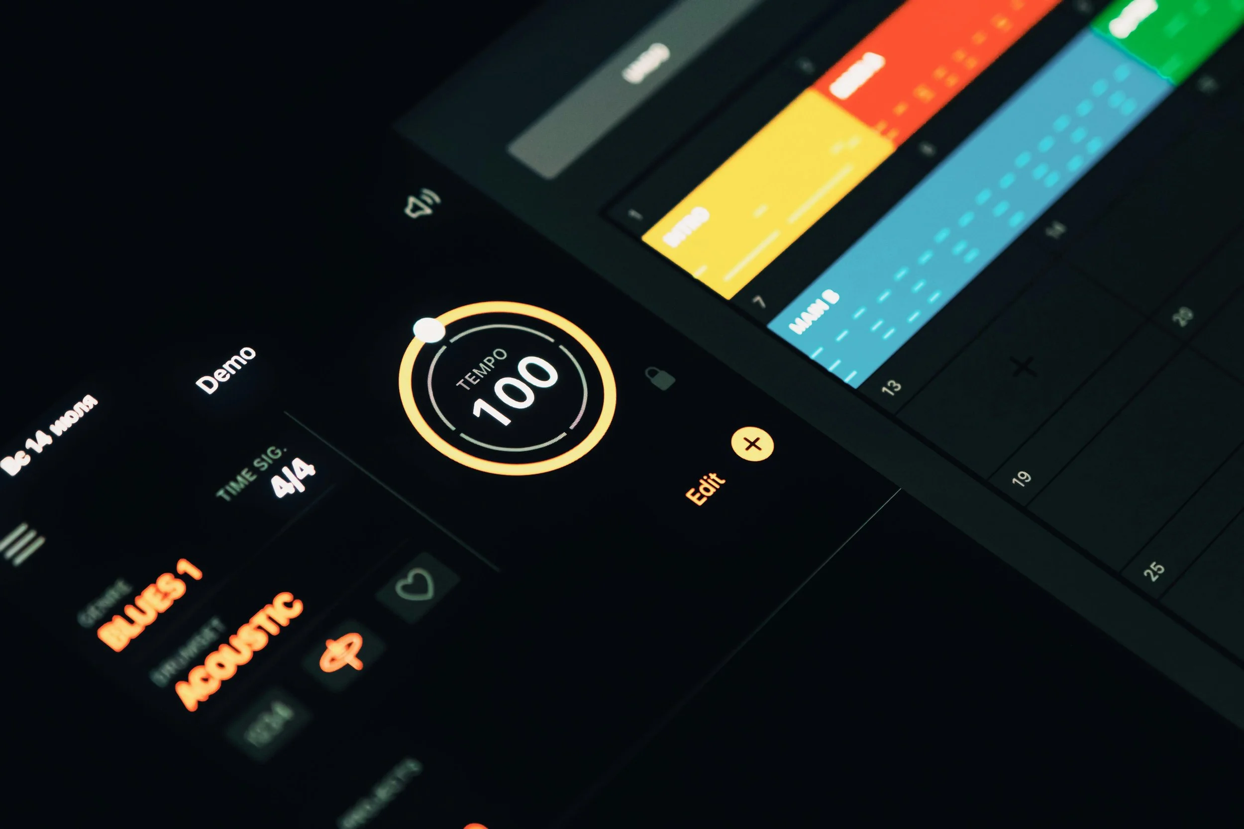 Close-up view of a digital music editing app on a tablet screen, showing editing controls, colored soundwave tracks, and a tempo knob set to 100.