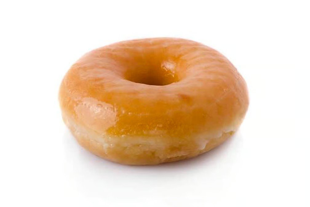 A glazed caramel-colored donut with a round shape and a hole in the middle on a white background.