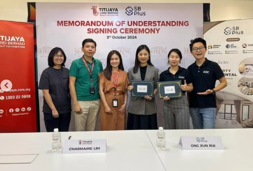 MoU of Sleepy Bear Group. Six people standing behind a white table at a signing ceremony, with a banner in the background that reads 'Memorandum of Understanding Signing Ceremony' and multiple logos, with two individuals holding framed documents.