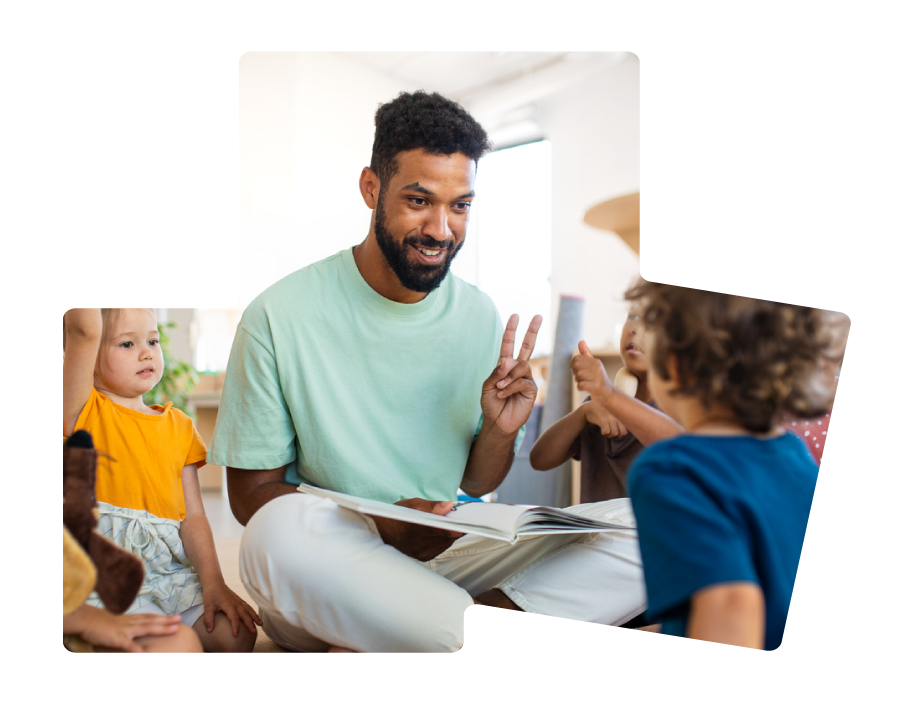 Adult reading a book to children, making a peace sign with his fingers in a bright indoor setting.