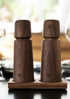 Set of two wooden salt and pepper shakers on a wooden tray