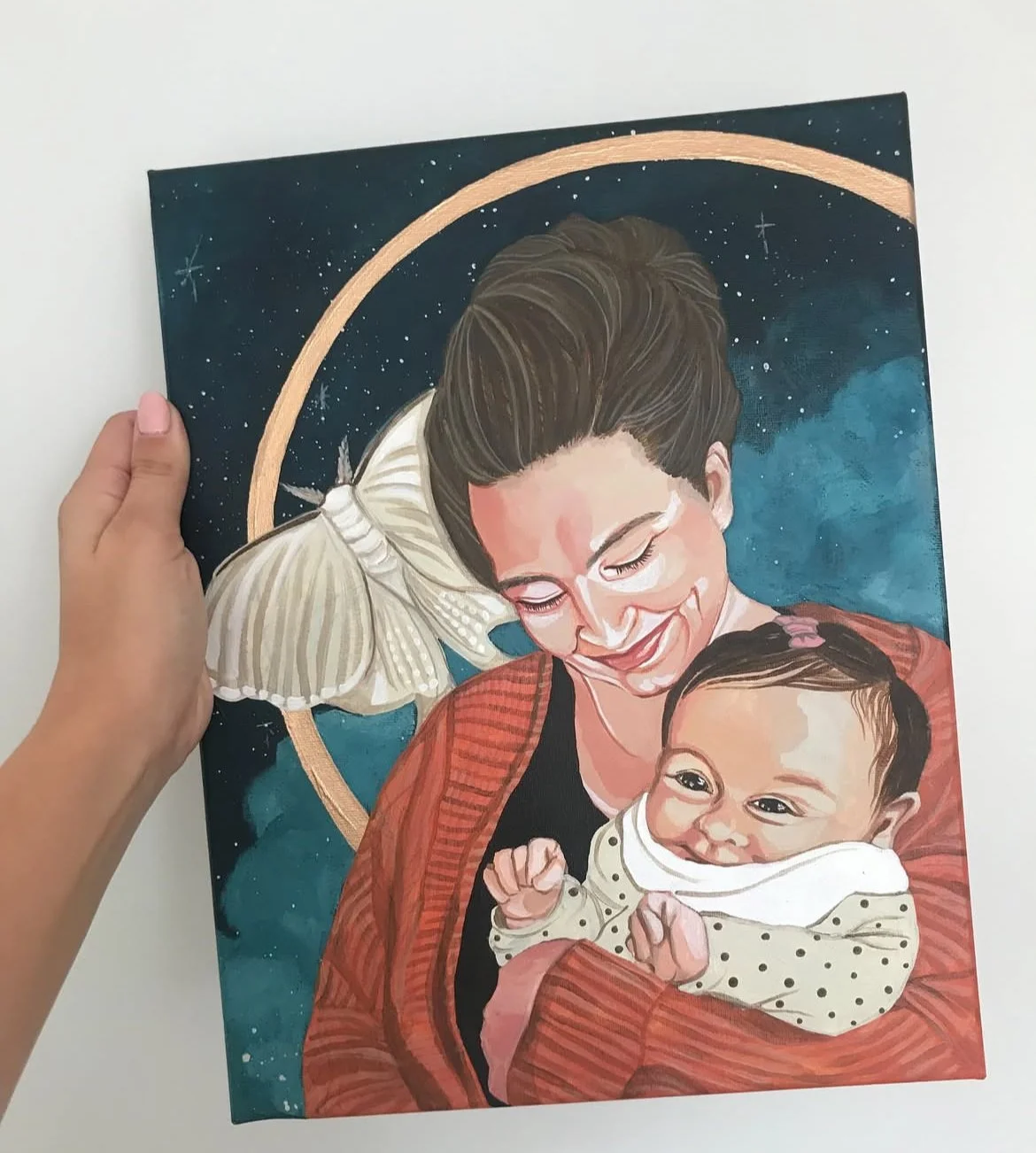 Painting of a woman and a baby against a starry night sky background, with a golden arc. The woman is smiling with her eyes closed, holding the baby who is looking forward with a cheerful expression.