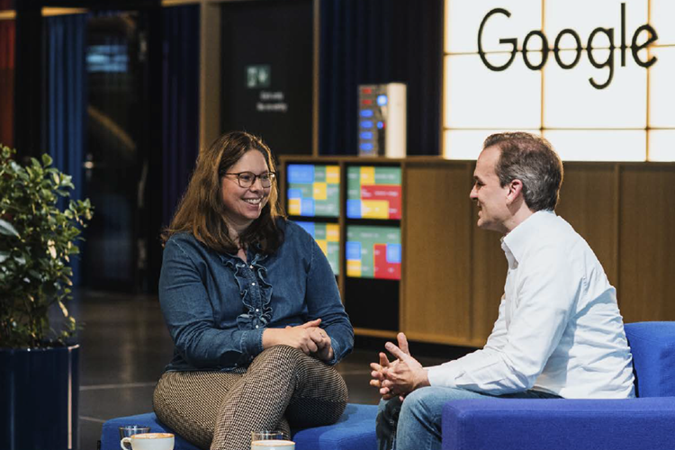 Jochen Menges speaking with a woman over coffee in a Google office.