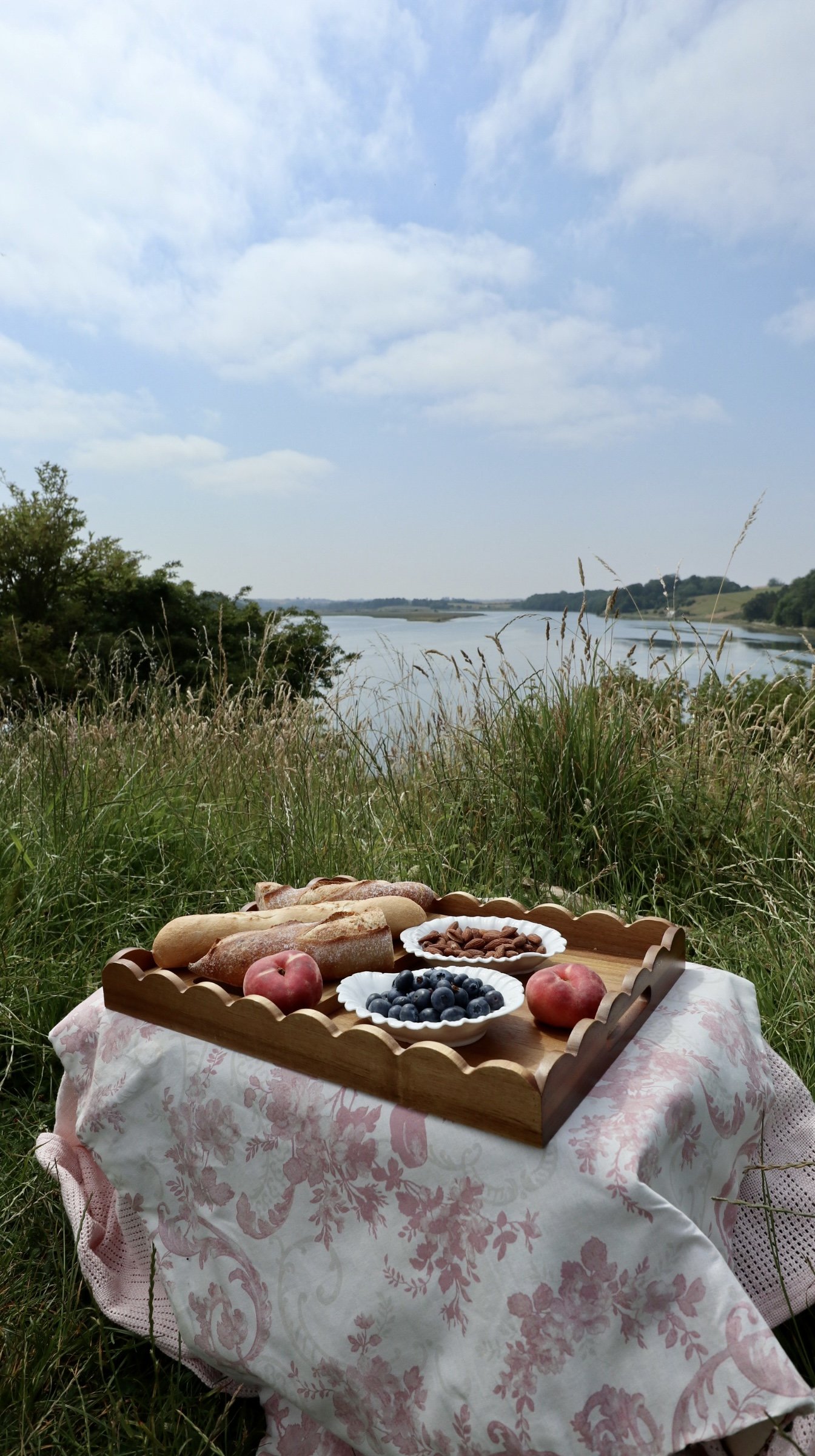 Small table with scalloped tray and river view.jpeg