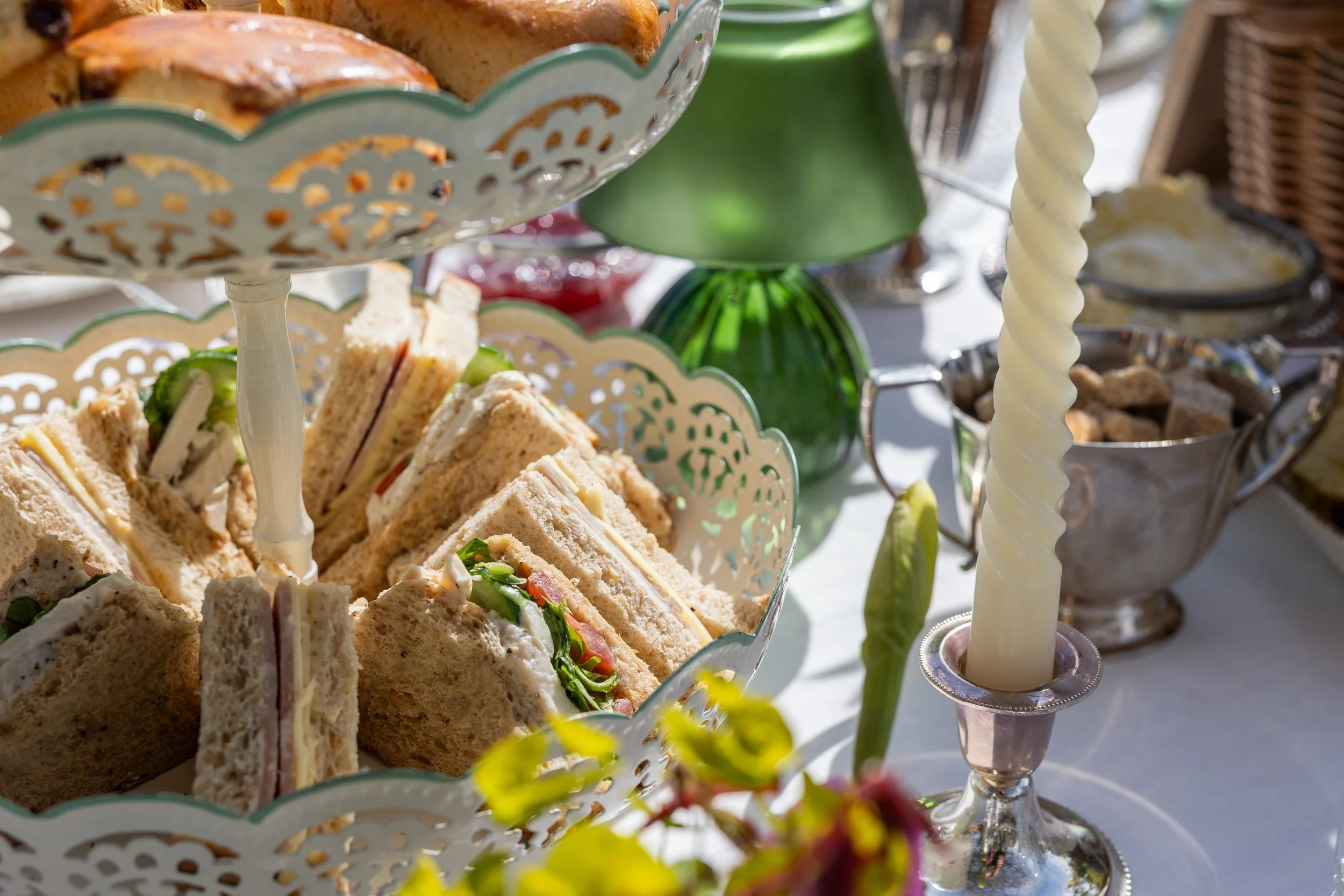 Afternoon tea details by Laura Somborn with tiered serving trays, delicate sandwiches, and soft decorative accents.