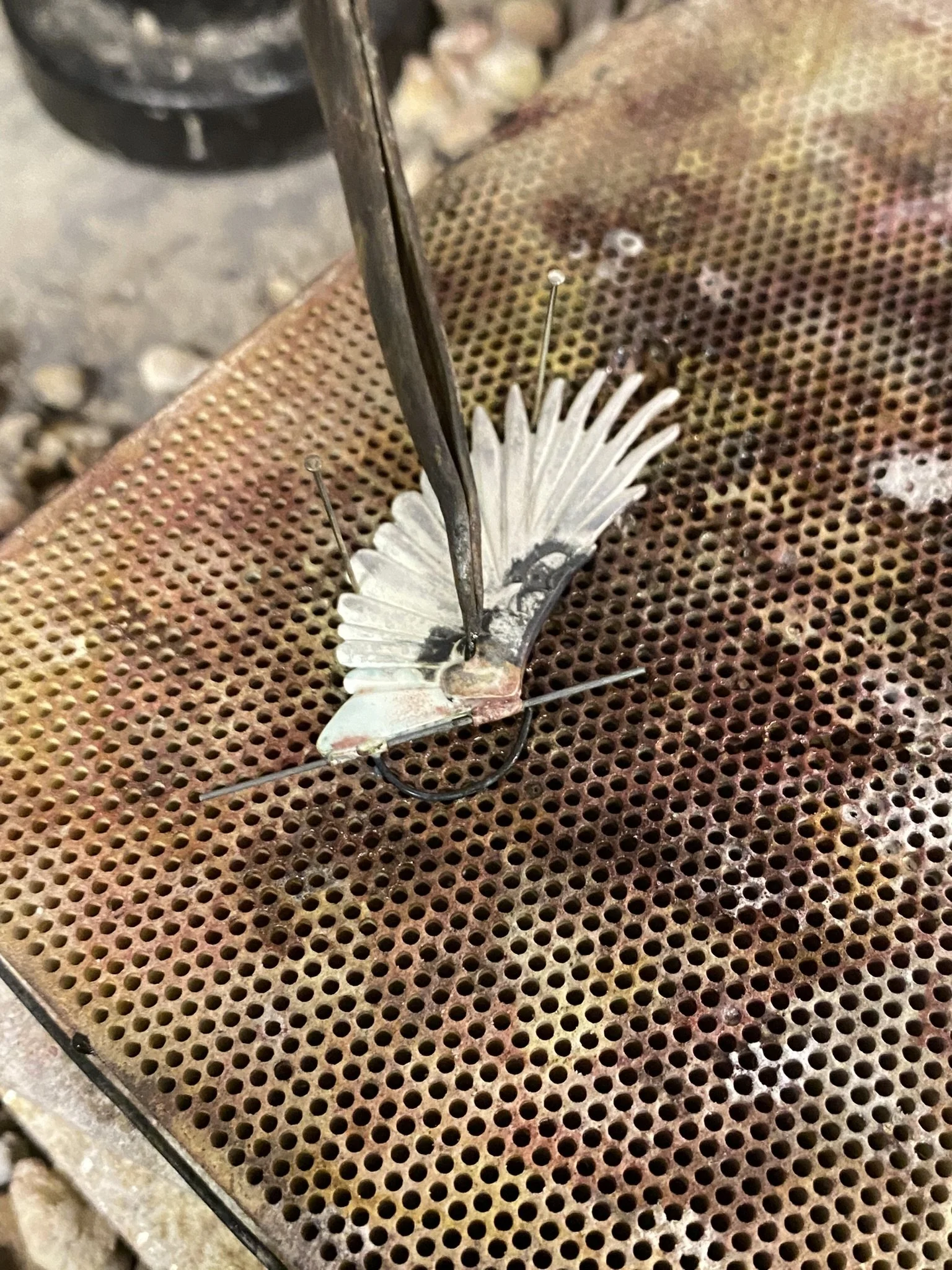 Soldering the hinges onto the wings.