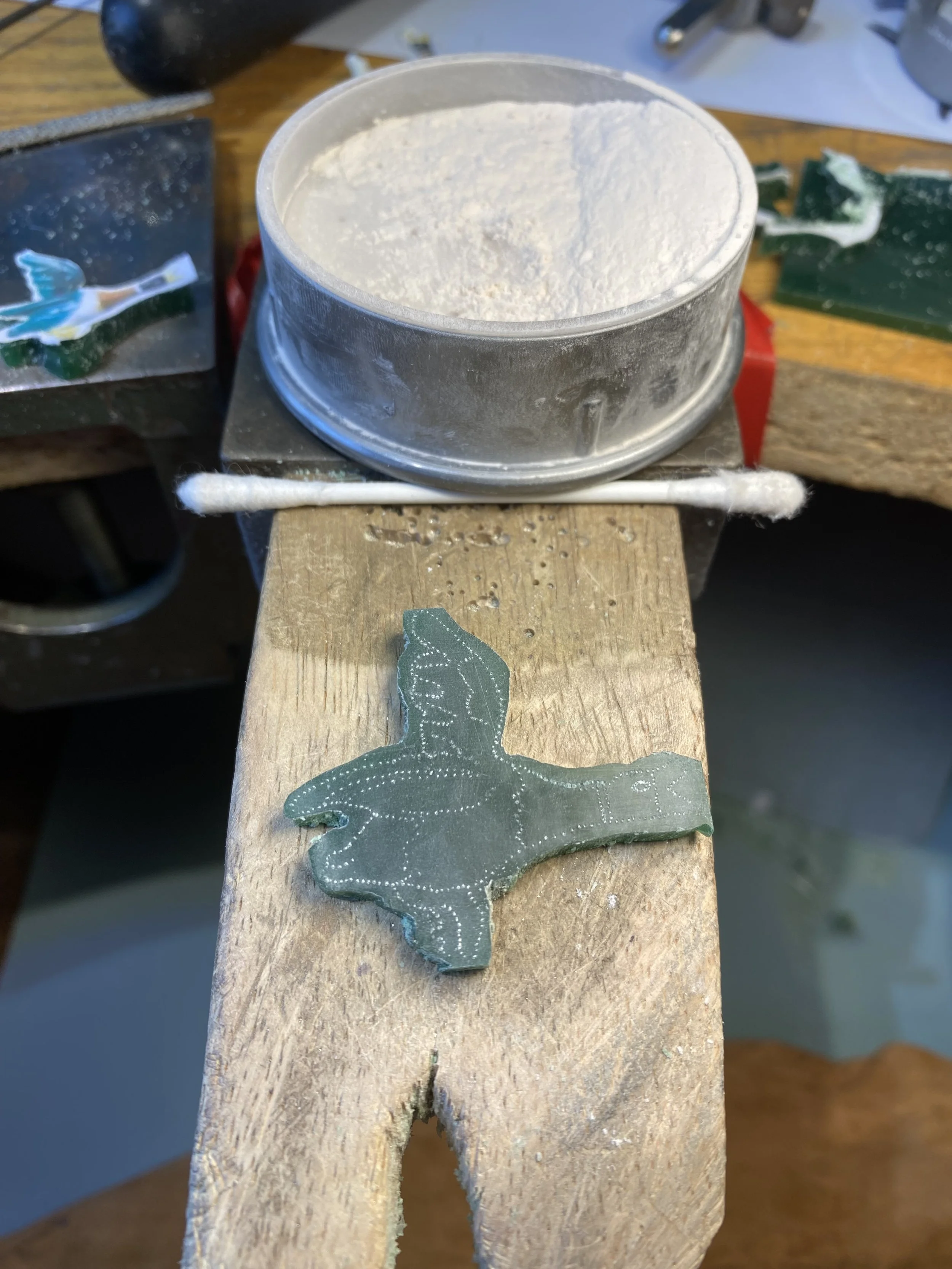 I use the pin and powder technique. I trace the detail from the template with a pin and then dust with talc powder to highlight the design underneath. 
