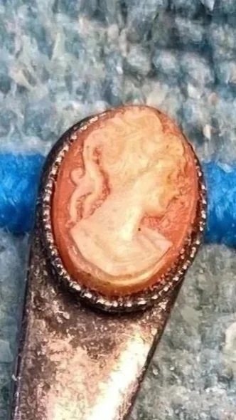 A humble antique mustard spoon, holding a beautiful cameo. Rather bizarre! 