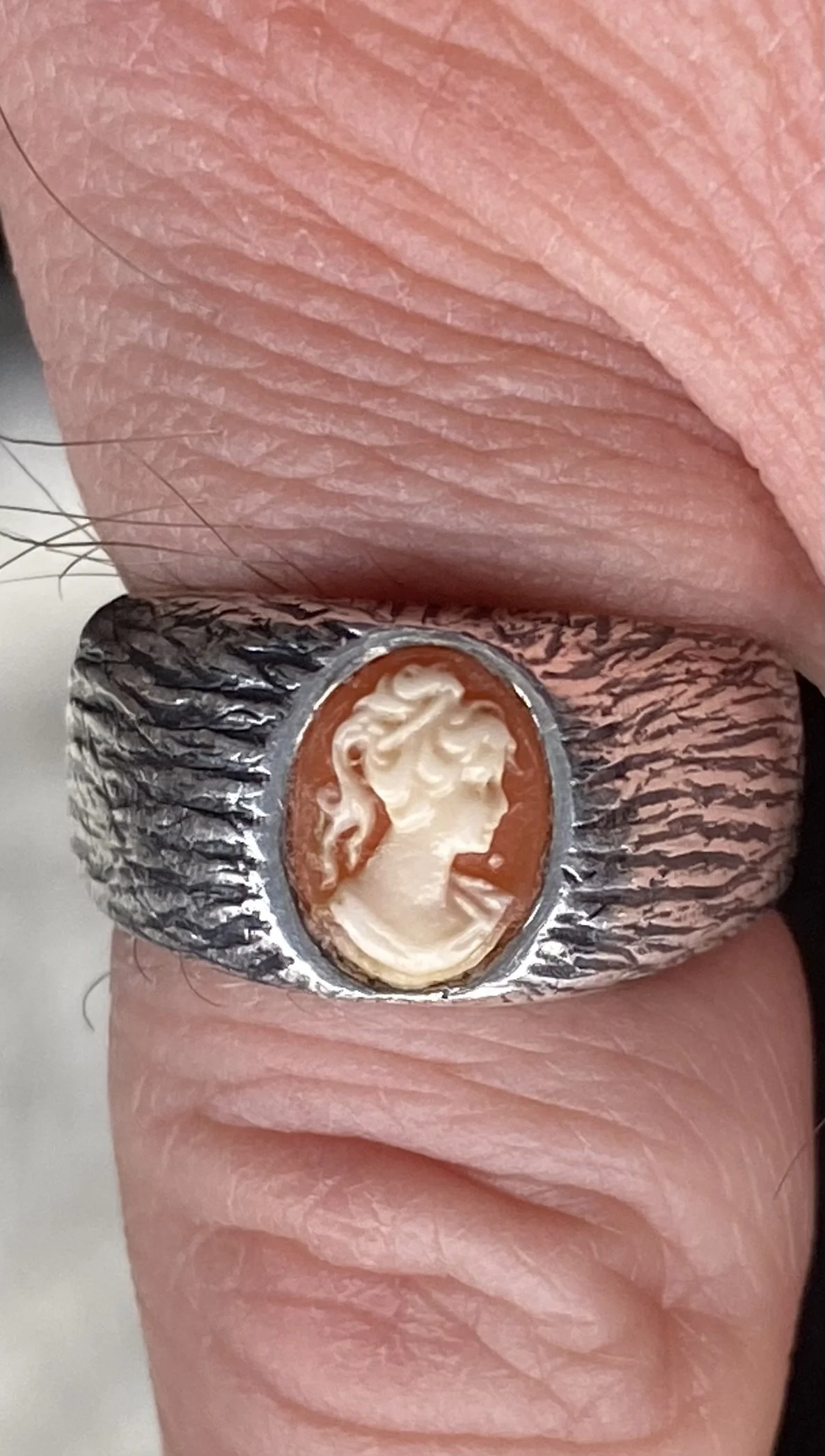 Cleaned the ring up after casting and burred out the setting for the cameo. Oxidised the ring, polished and then set the cleaned cameo to the ring. 