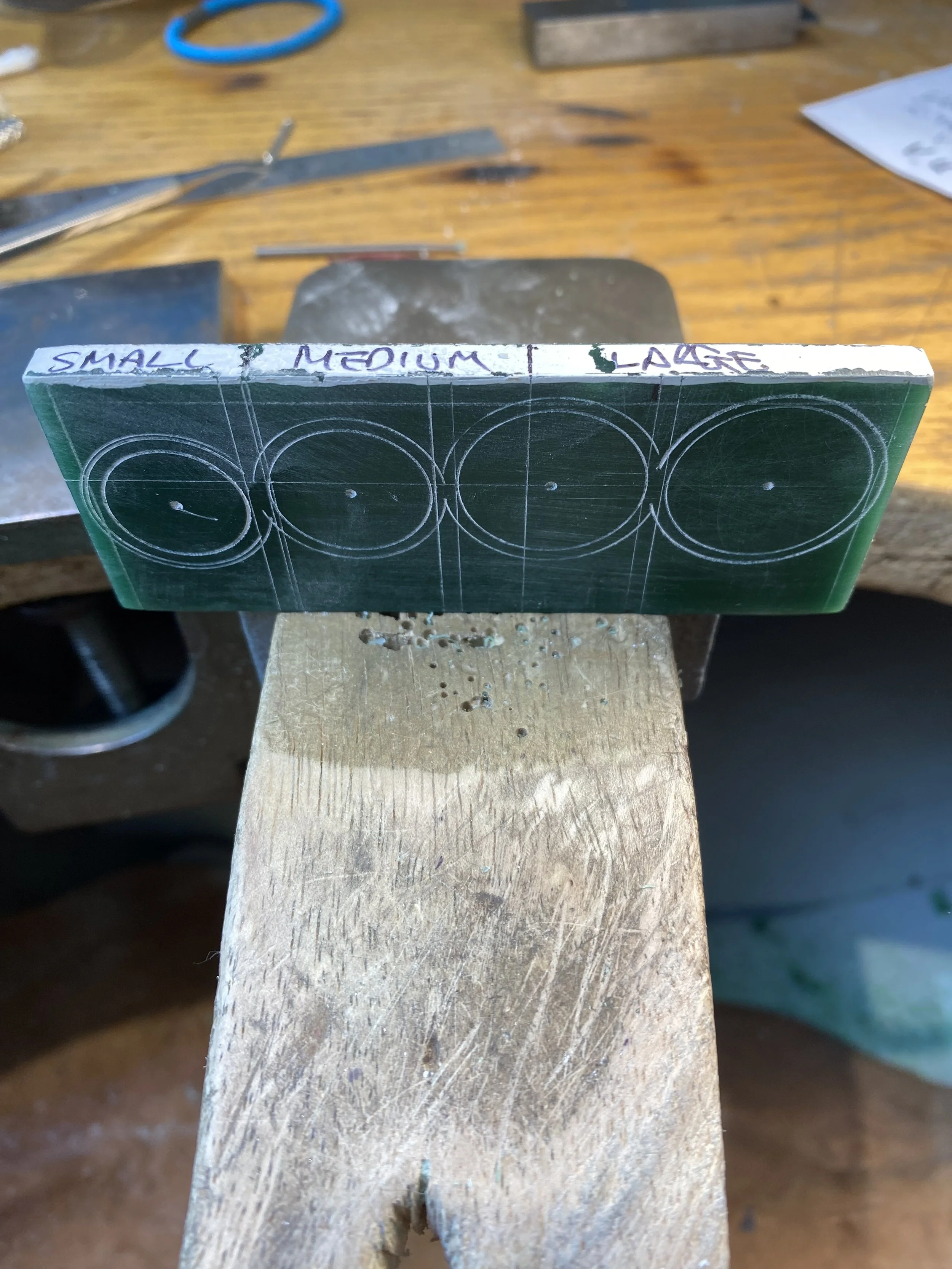 Transferring the four finger sizes onto a slab of wax. Using the silver ducks as a placement guide to see where these need to be placed across the hand. 