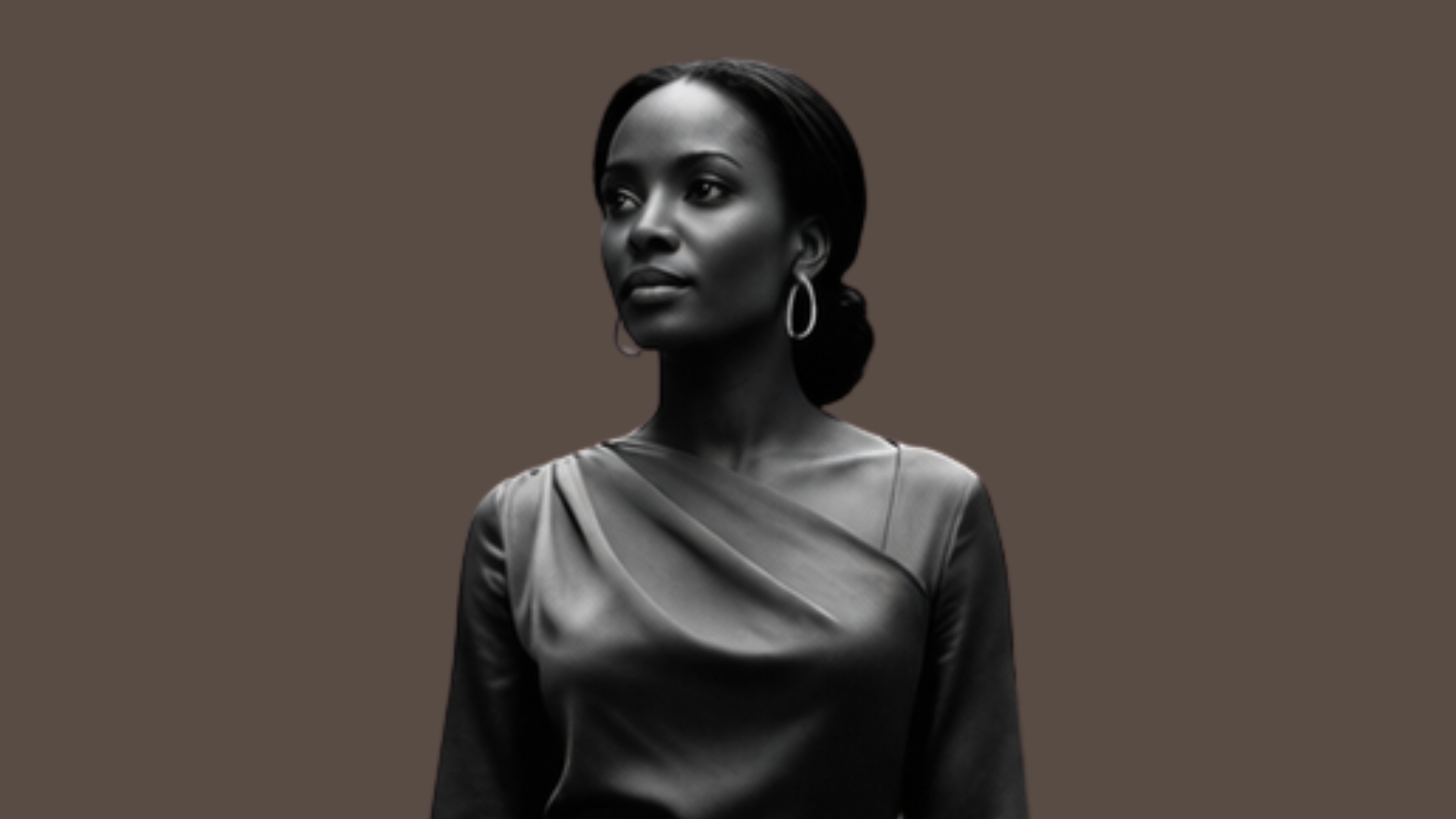 A black and white portrait of a woman with hoop earrings and a satin top, standing against a plain background.