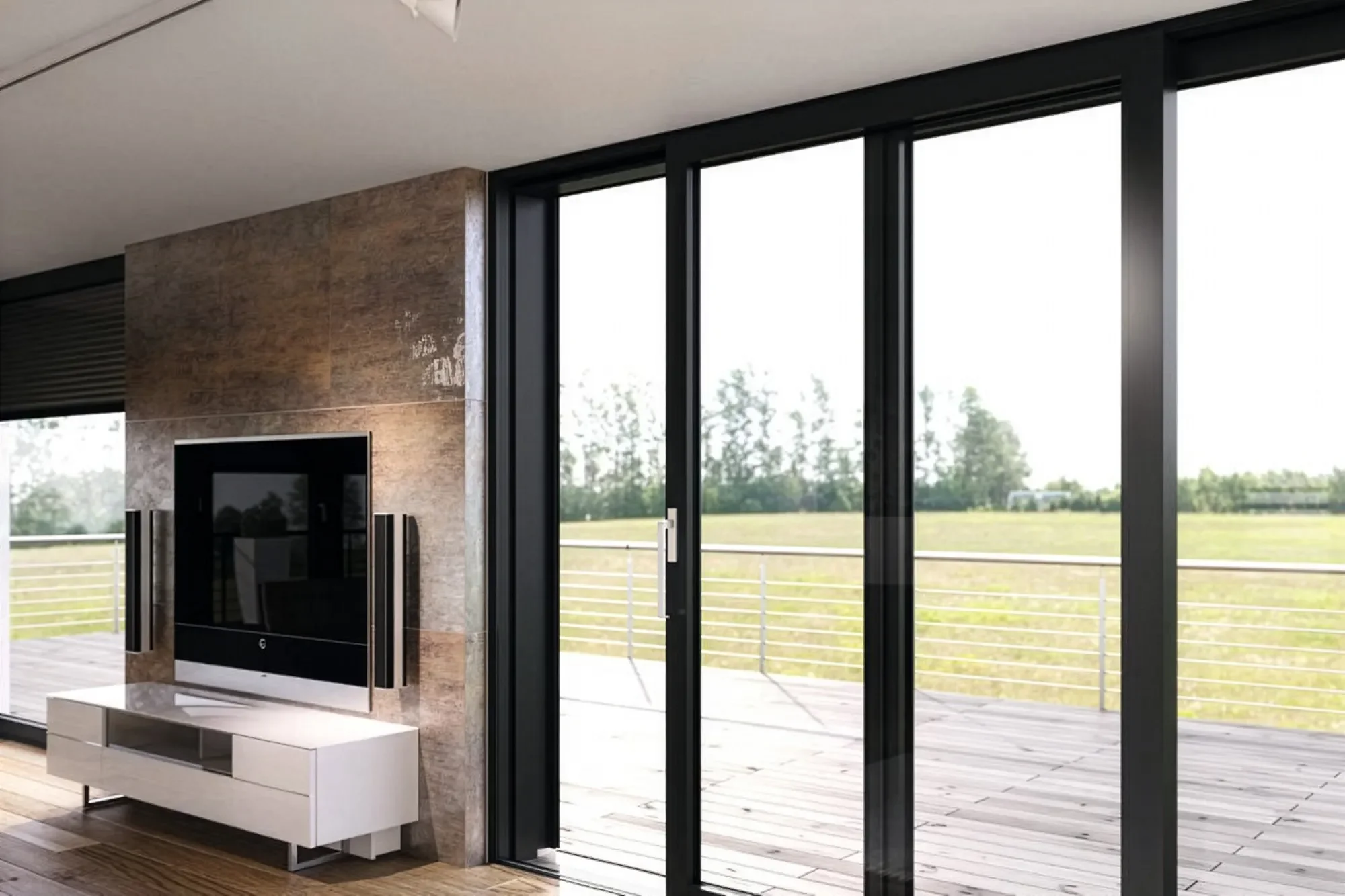 Modern living room with a large sliding glass door leading to an outdoor deck and a view of grassy fields and trees.