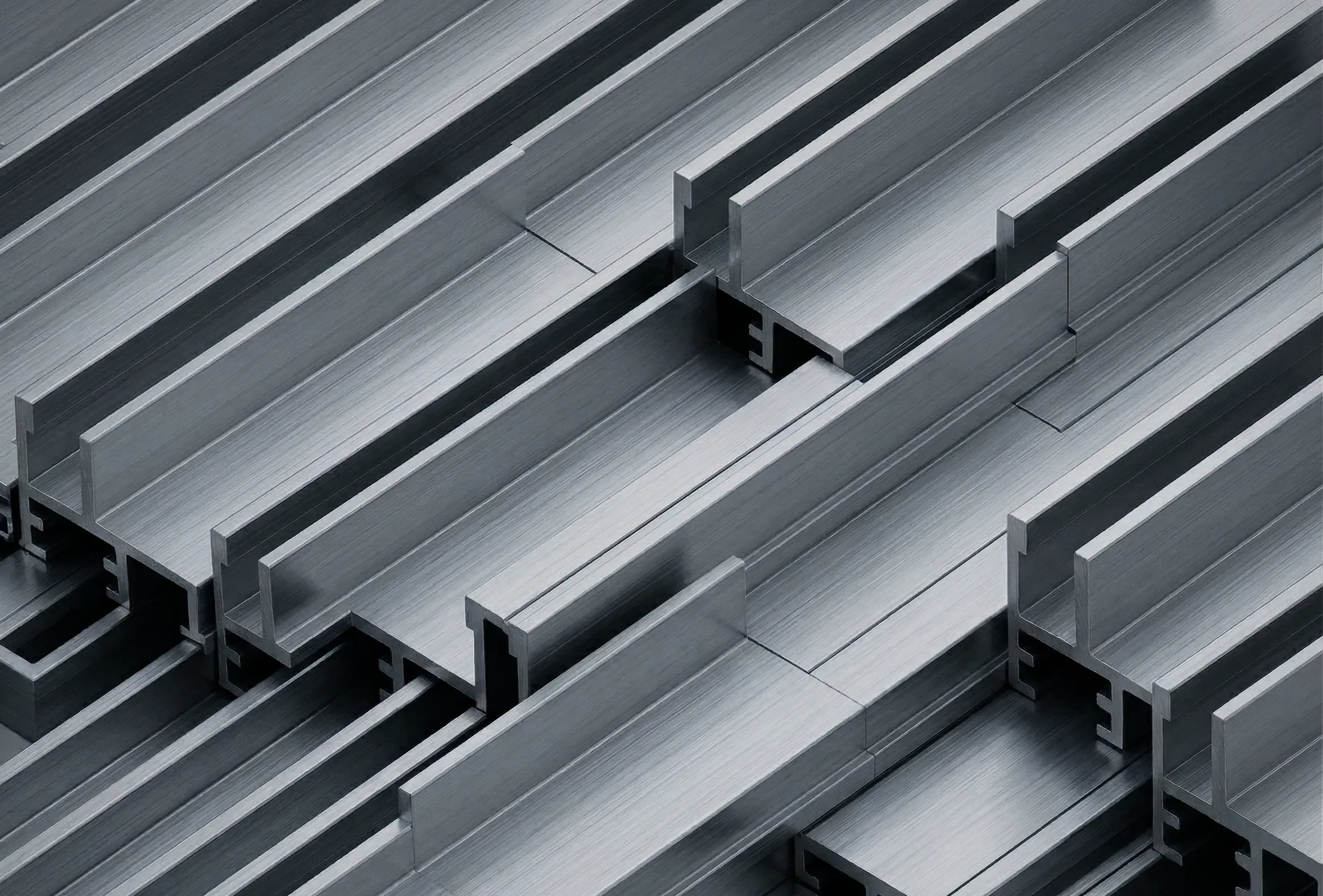 Stacked aluminum extrusion profiles with a brushed finish.