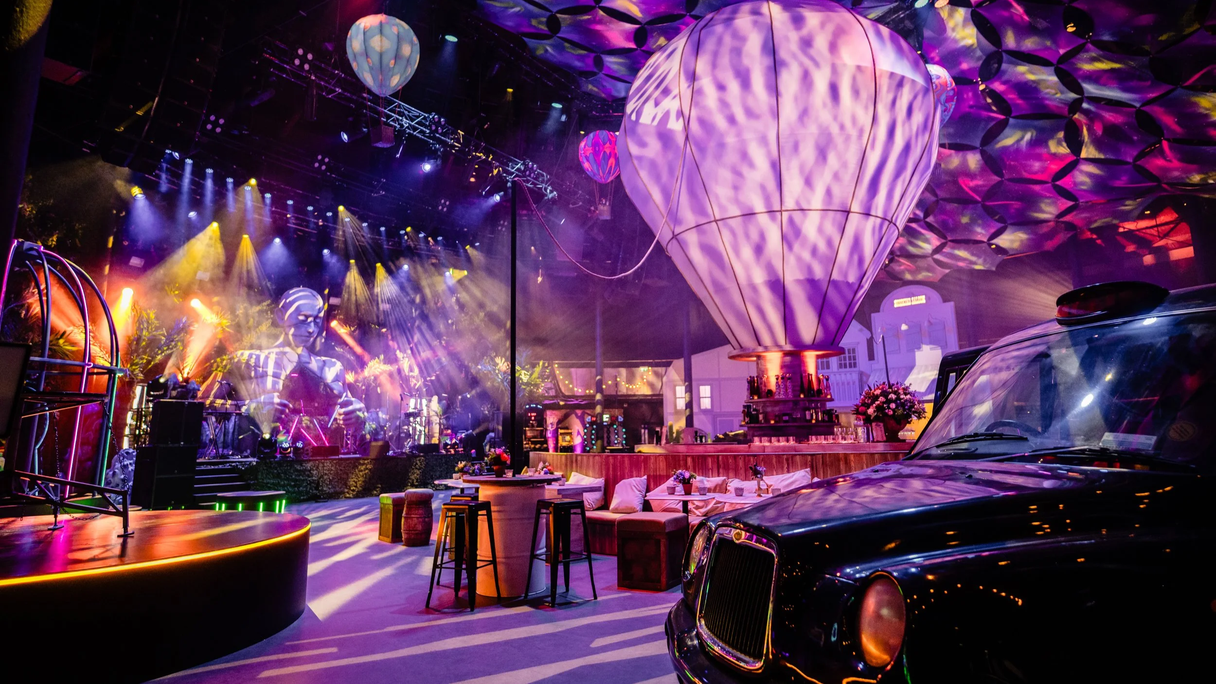 Roundhouse Bar Mitzvah celebration. Camden punk style, lots of colour with vibrant lights, hot air balloons, and vintage cars on display.
