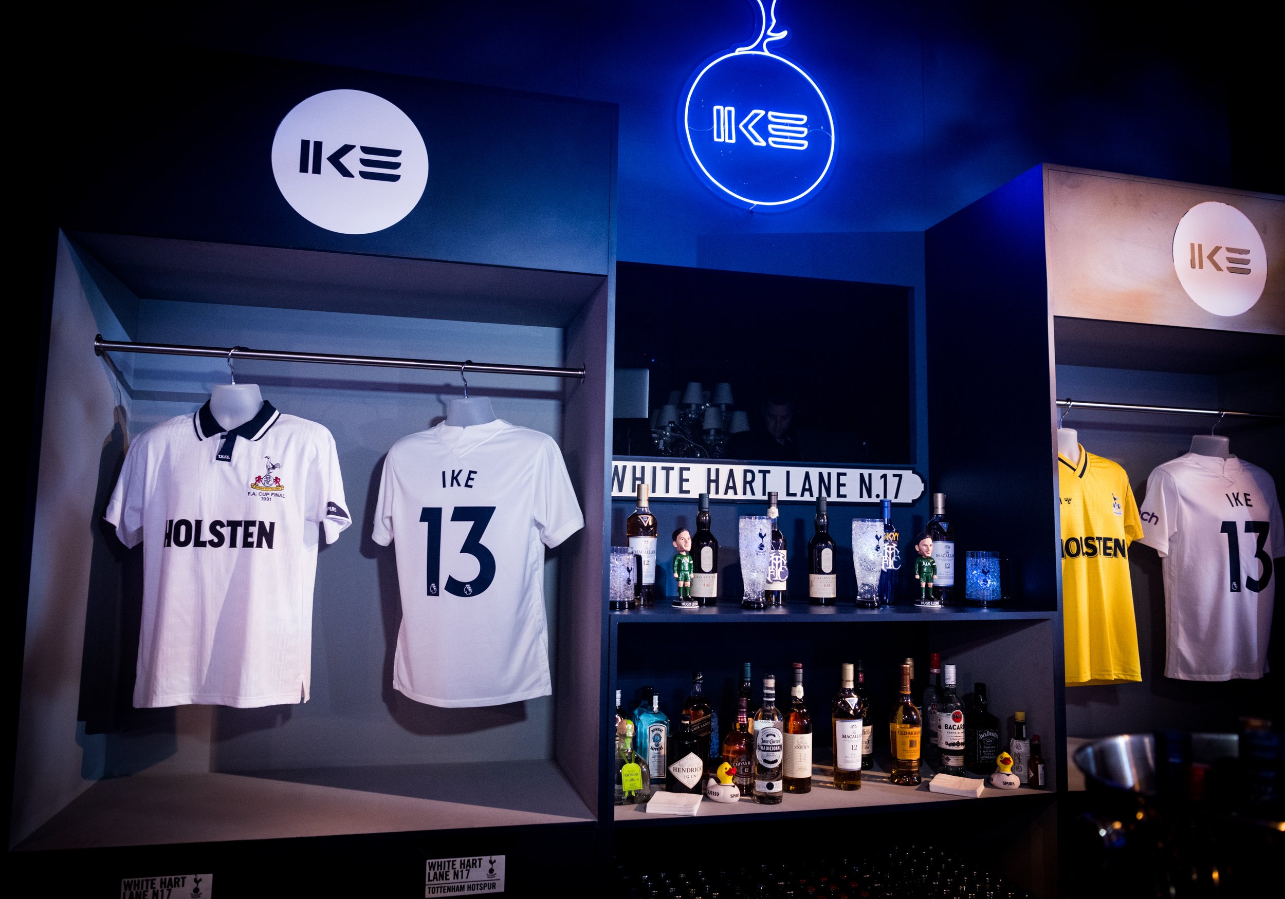 Display of Tottenham Hotspur football jerseys and bottles of liquor on a bar for a Football themed luxury Bar Mitzvah