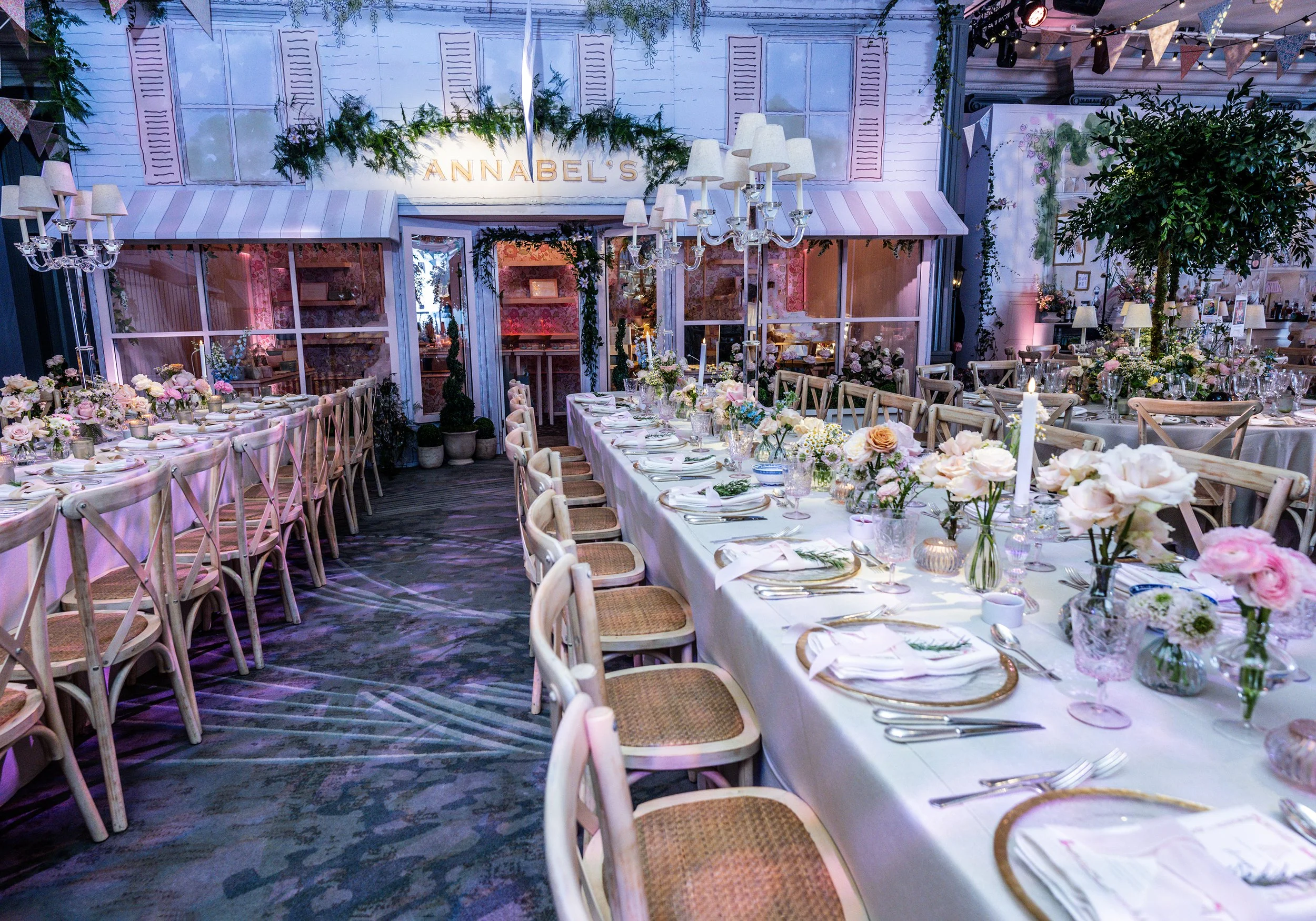 Grosvenor House on Park Lane decorated with long tables, floral centerpieces, candles, and string lights, for a Bat MItzvah celebration