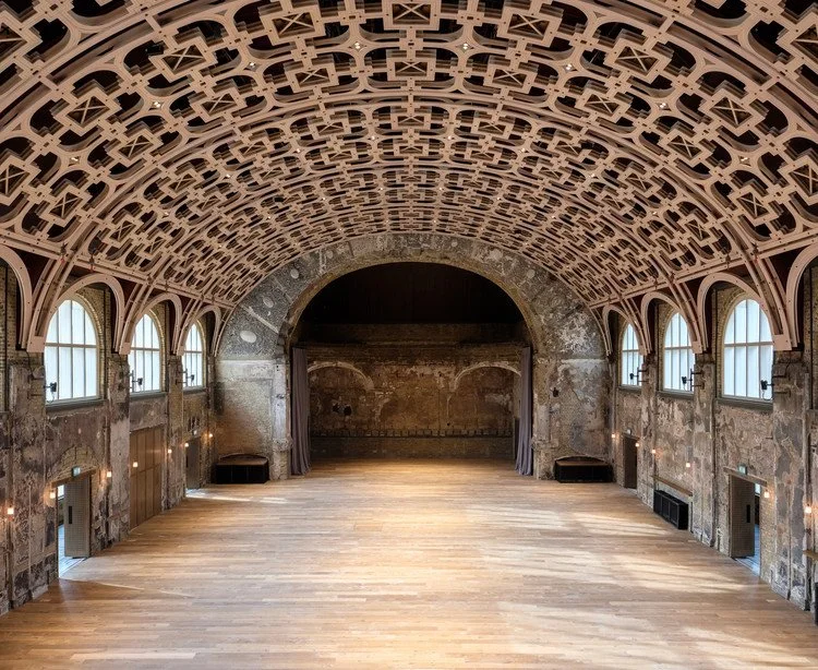 The Grand Hall at Battersea Arts Centre, empty, showing its restored lattice ceiling and exposed original brickwork