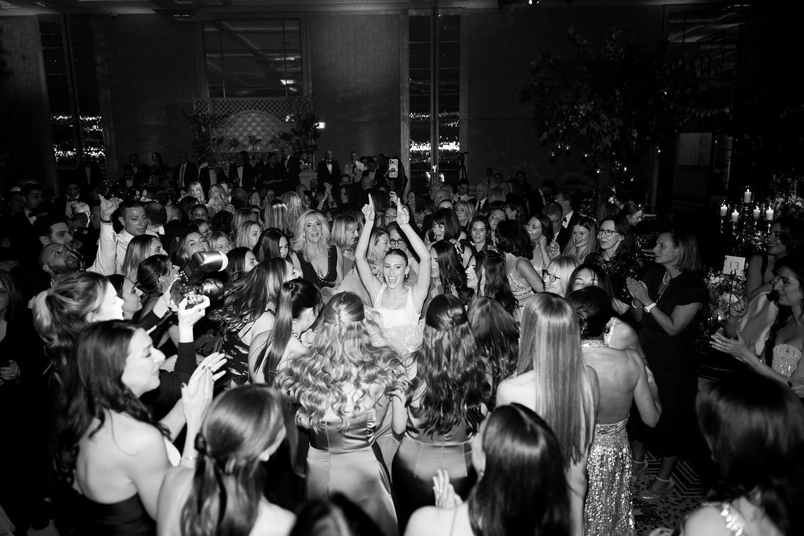A large crowd of women dressed enjoying the wedding at The Peninsula London