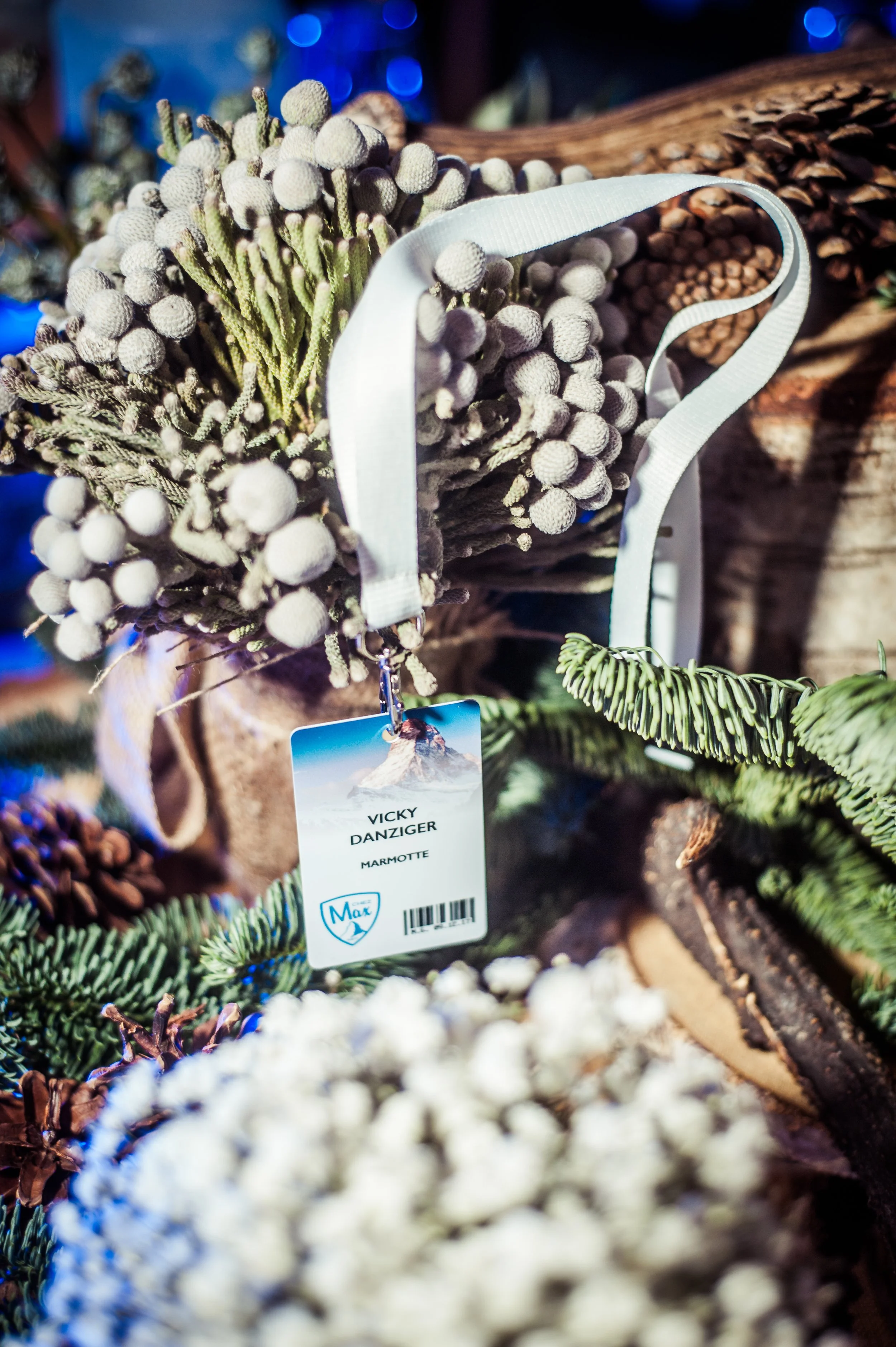 Close-up of a bundle of artificial white berries, likely for decoration, tied with a white ribbon, with a tag indicating the product is from Vicky Danziger, Marmotte, and branded Max.