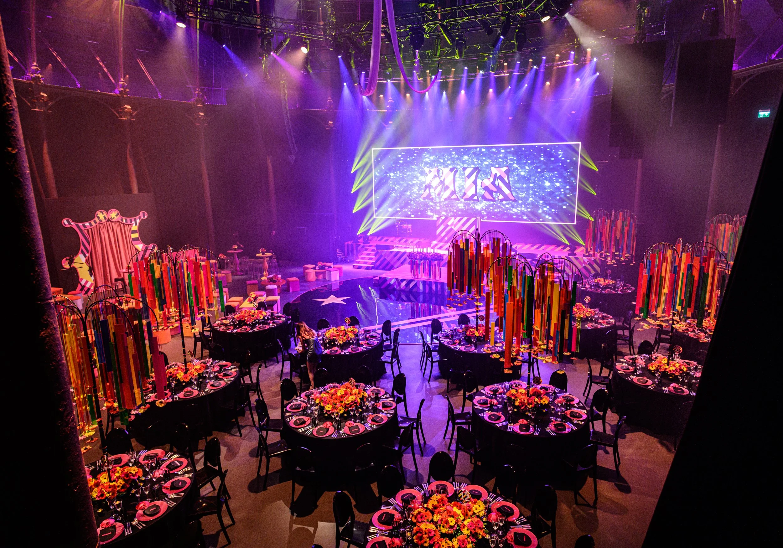  Bat Mizvah the roundhouse A large stage with bright lighting and a digital screen is in the background, with lighting effects creating an energetic atmosphere.