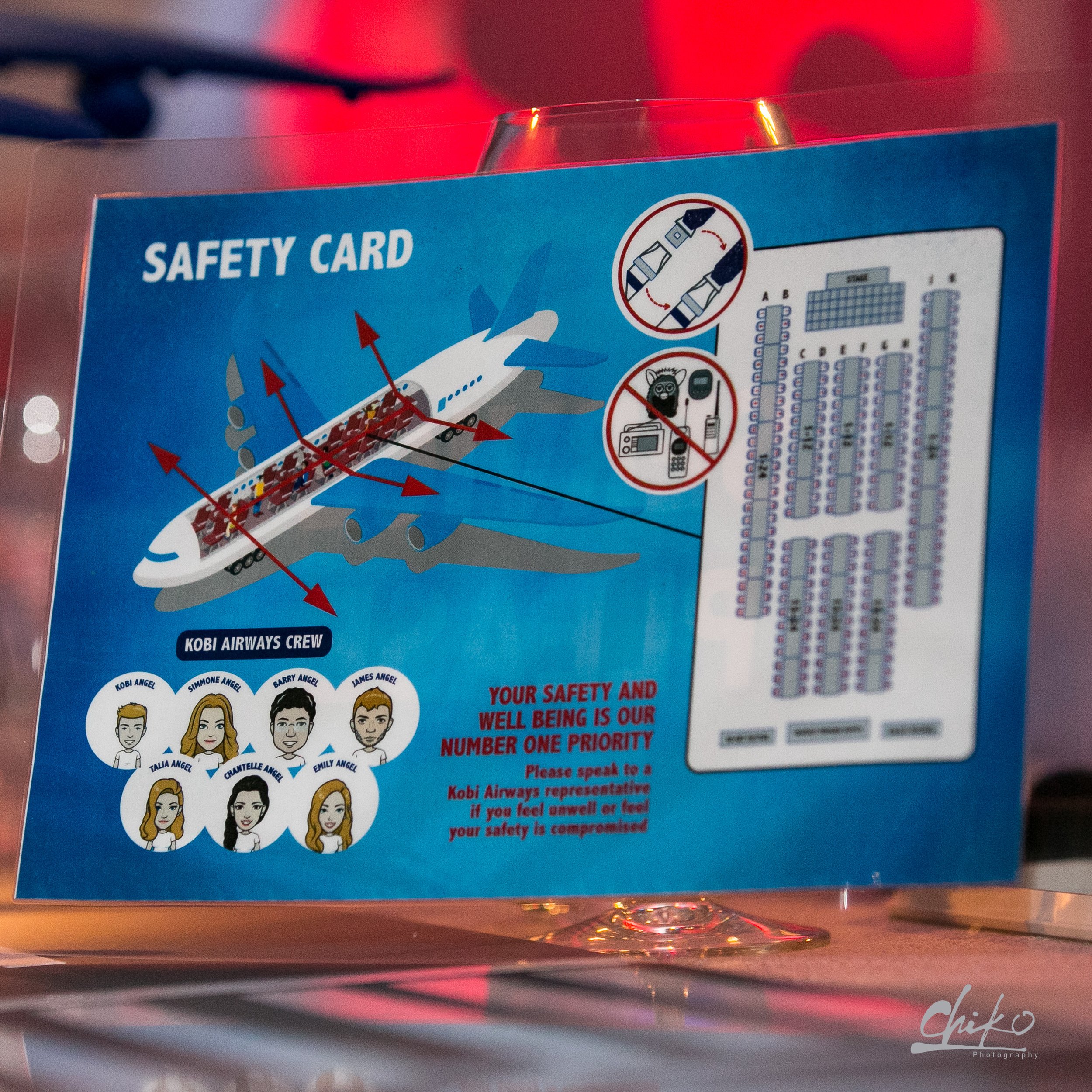 A safety card for Kobi Airways with illustrations of airplane emergency procedures and cartoon portraits of crew members.