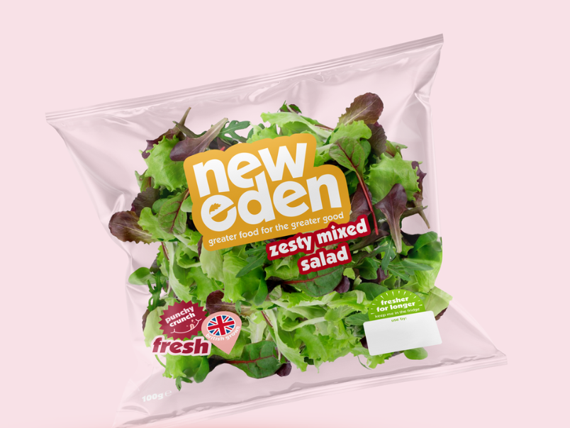 A bag of pre-packaged mixed salad greens with a pink background, labeled "New Eden," "zesty mixed salad," and "fresh."