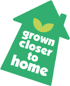 Green house-shaped sign with a leaf graphic and the text "grown closer to home."