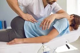 A person receiving a chiropractic adjustment from a healthcare professional.