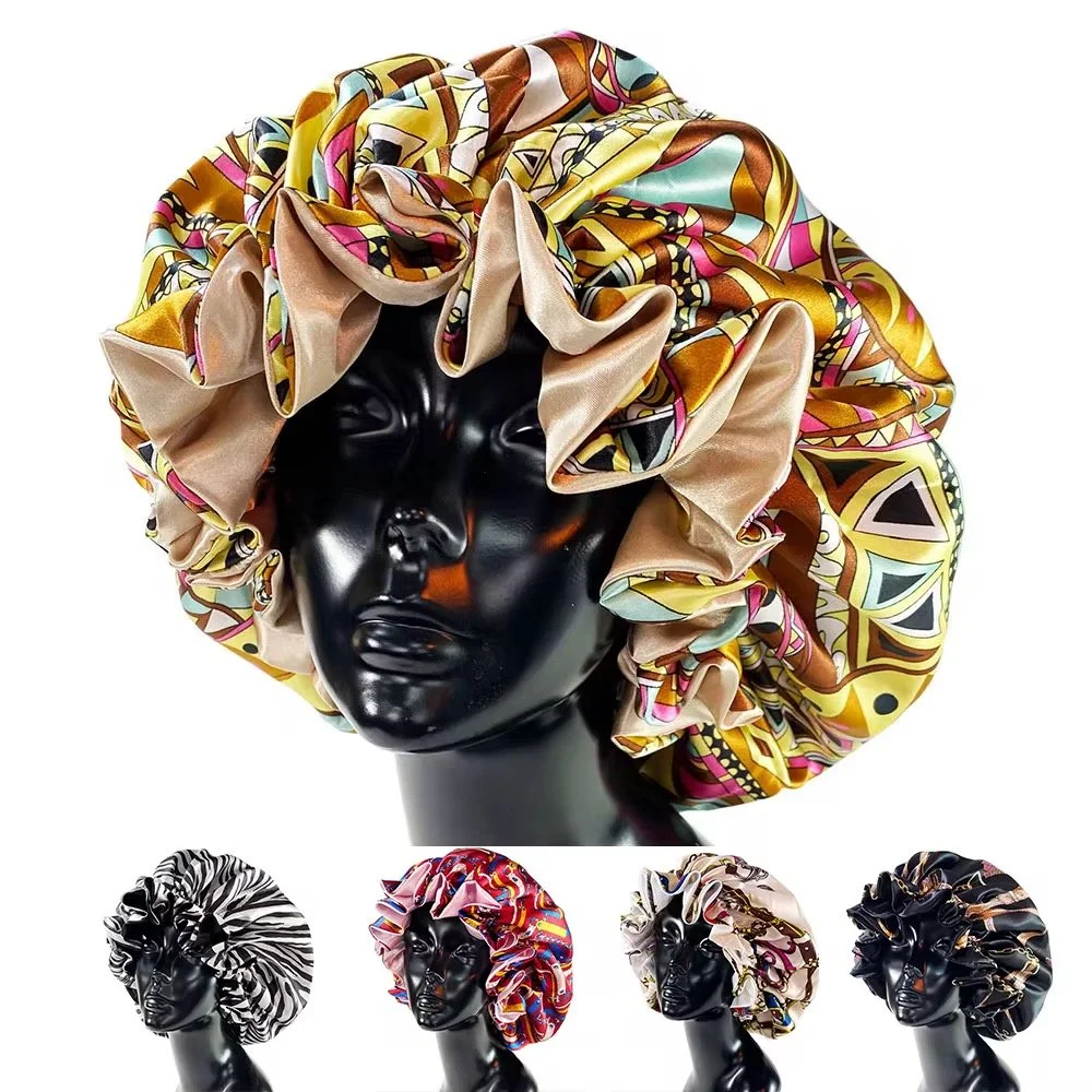 A black mannequin head wearing a colorful, patterned satin bonnet with ruffles. Four additional bonnets with different patterns are displayed below.