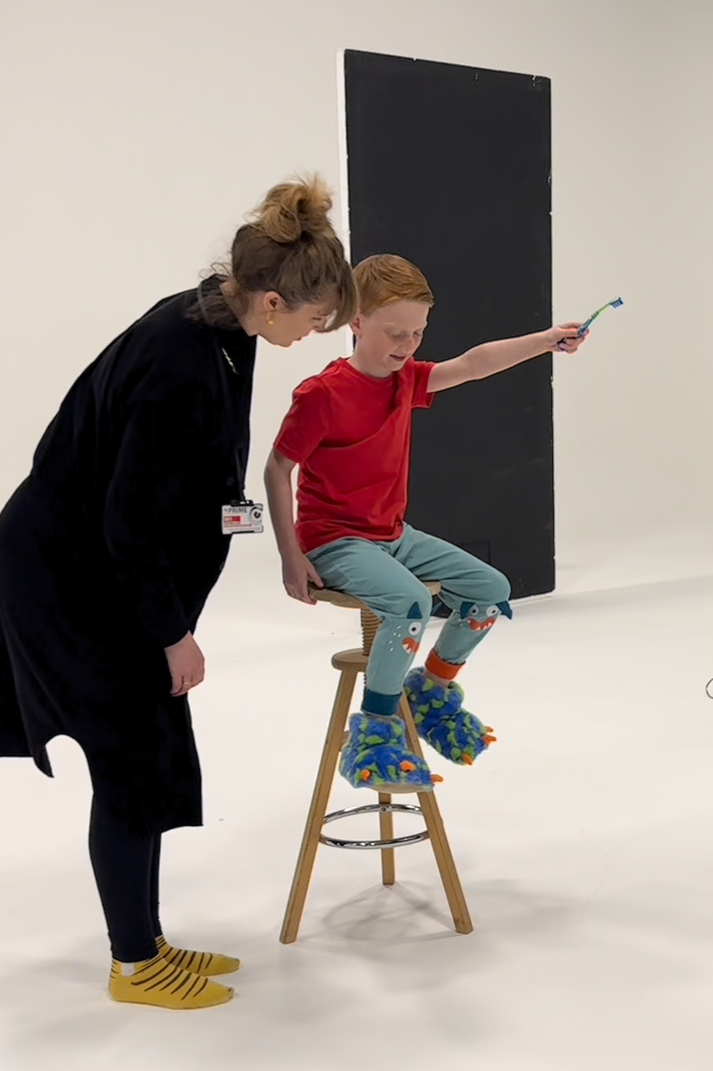 Melanie Hill working on set with a child