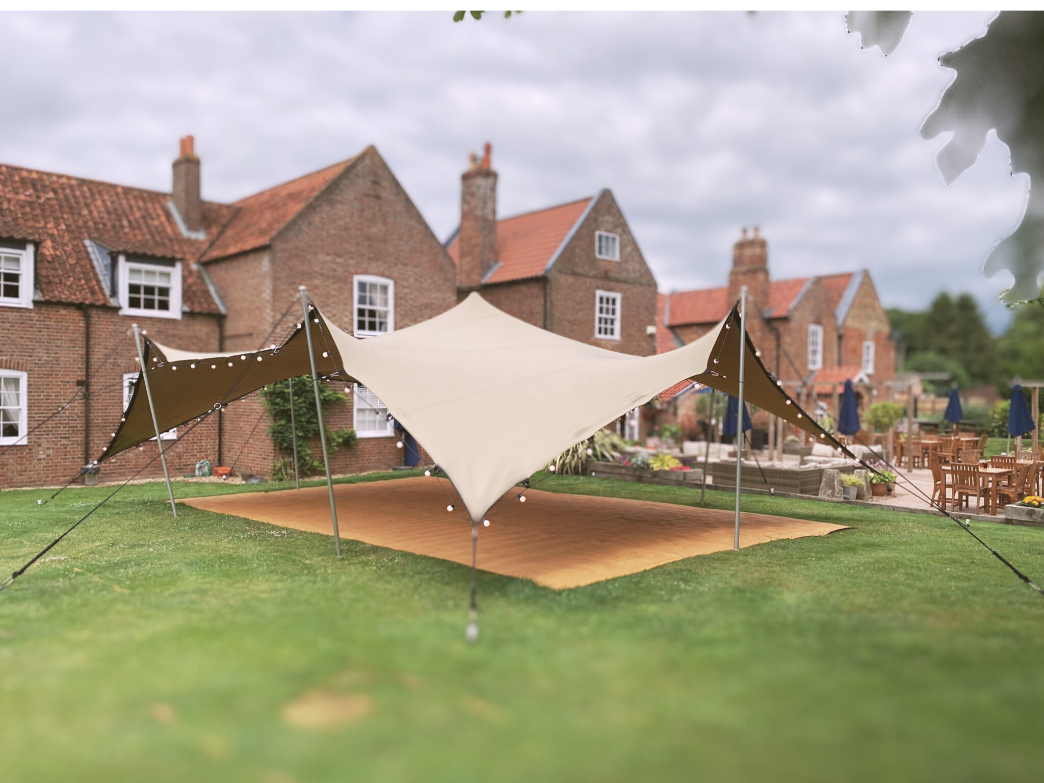 Stretch tent with festoon lights on grass stretch tent hire leeds stretch tent rental garden party stretch tent hire Wakefield west yorkshire wedding leeds wedding beer garden marquee leeds marquee York stretch tents Manchester canopy pub shelter