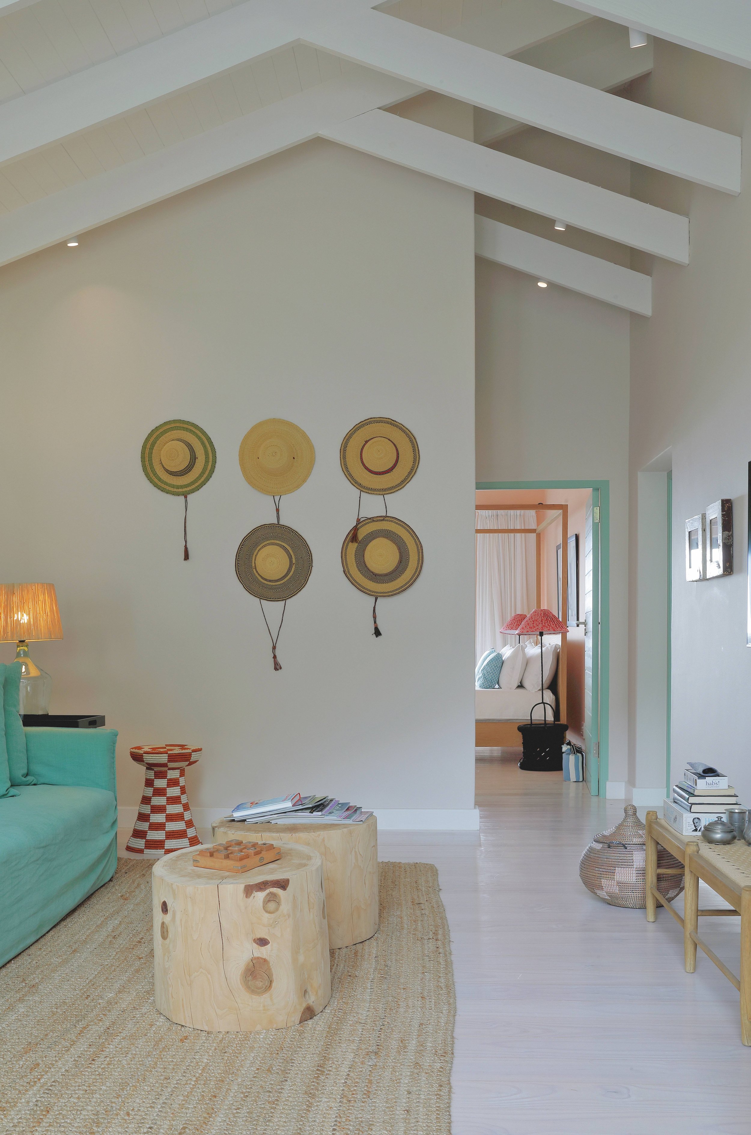 Bright coastal living room with natural cane and seagrass textures, Llandudno Cape Town holiday home interior design by Anja Lehne | Fabliving
